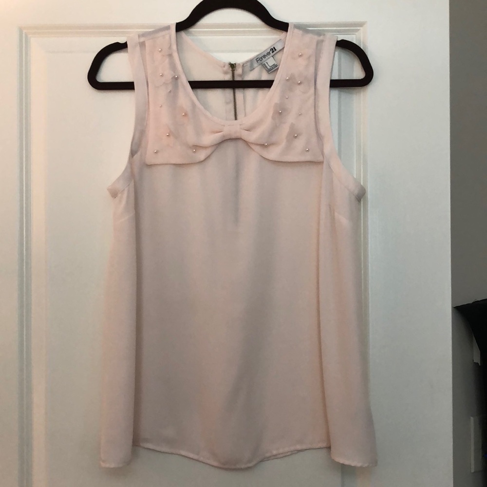 Sleeveless peach blouse w/ pearl detail